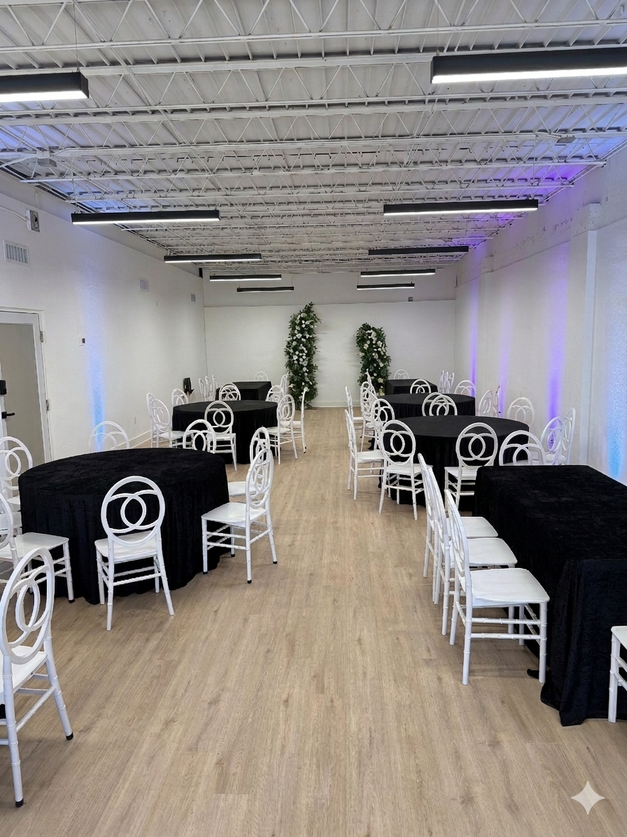 The suite set with black velvet tables, white chairs, and tall floral pillars
